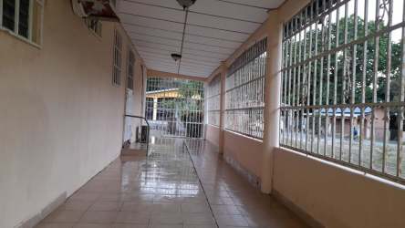 Covered tiled exterior walkway with metal gate and security bars Las Tablas Panama property