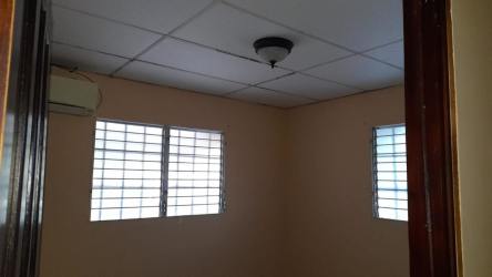 Interior small room with barred windows, drop ceiling, air conditioner Las Tablas house