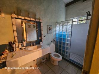 Large bedroom with ceiling fan and rustic decor villa Coronado Panama