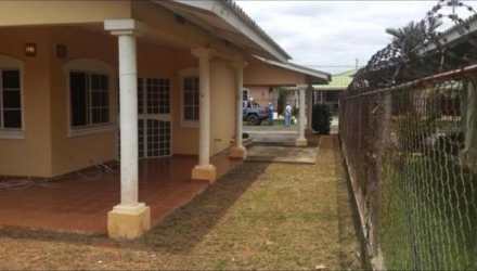 Covered backyard patio and garden area in Residencial Los Guayacanes house for sale in Chitre Panama