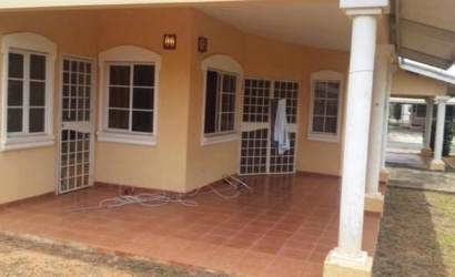 Exterior porch area with security bars, pillars, and garden at Residencial Los Guayacanes in Chitré Panama