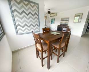 Dining room with tile flooring connected to kitchen area, PH Woodland Panama Pacifico apartment for sale
