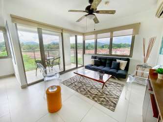 Bathroom with glass shower, vanity sink, tiled walls at PH Woodland Panama Pacifico