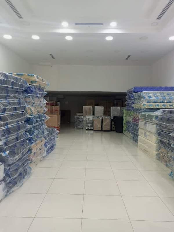 Interior warehouse with mattresses and appliances stacked inside Los Andes Mall Panama commercial rental