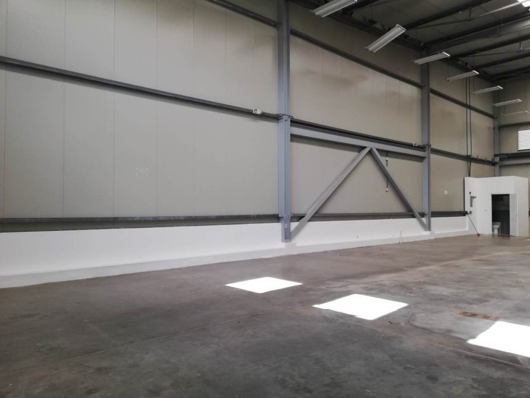 Empty industrial warehouse with concrete floor, high ceiling at Las Mañanitas Panama