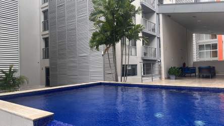 Walk-in closet with built-in shelves and hanging space in PH Mosaic Panama Pacifico