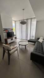 Living room with large windows modern furnishings in PH Mosaic Panama Pacifico