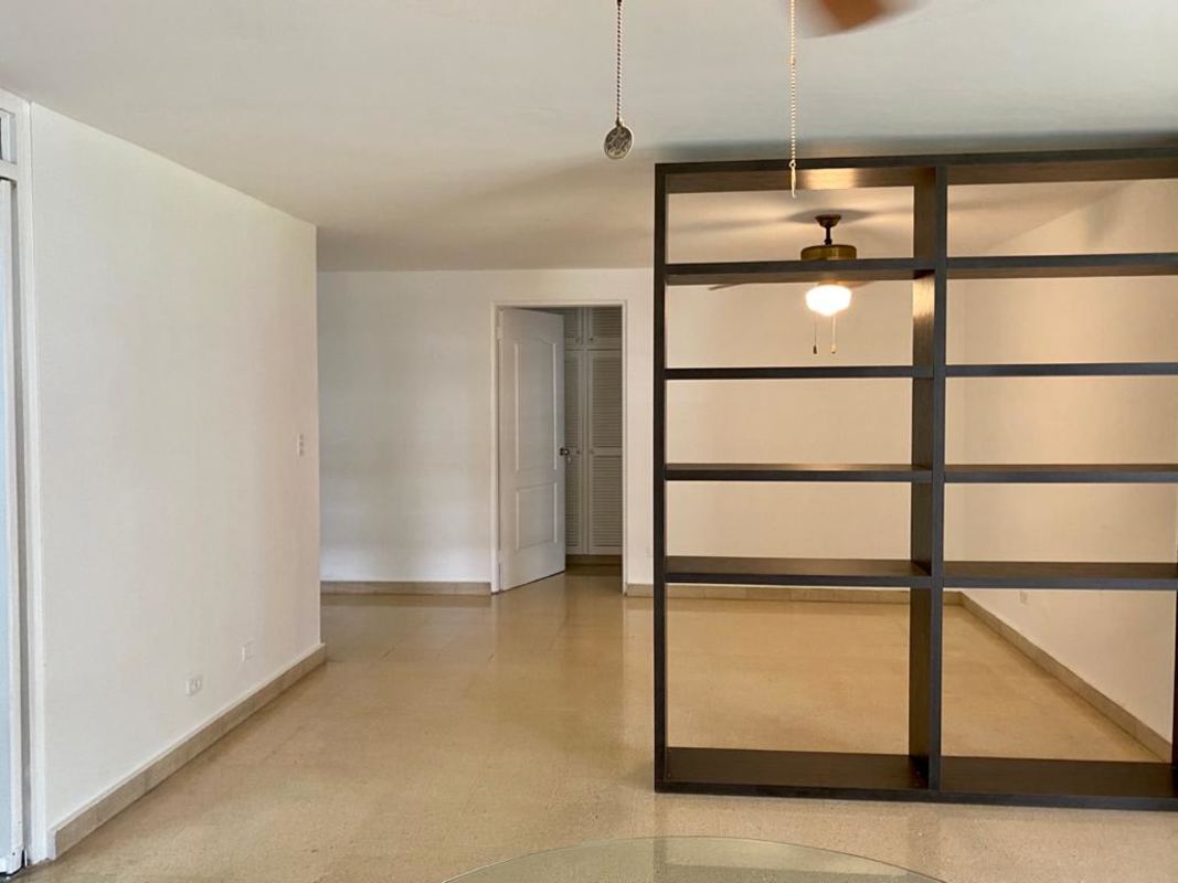 Bright living room with tile floors, ceiling fan, bookshelf divider at PH Bella Vista Park by Parque Urracá Panama
