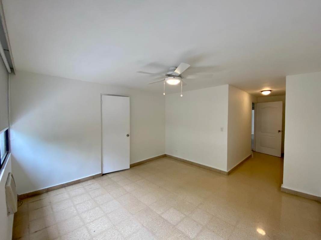 Spacious bedroom with large window and ceiling fan in PH Bella Vista Park Panama City apartment