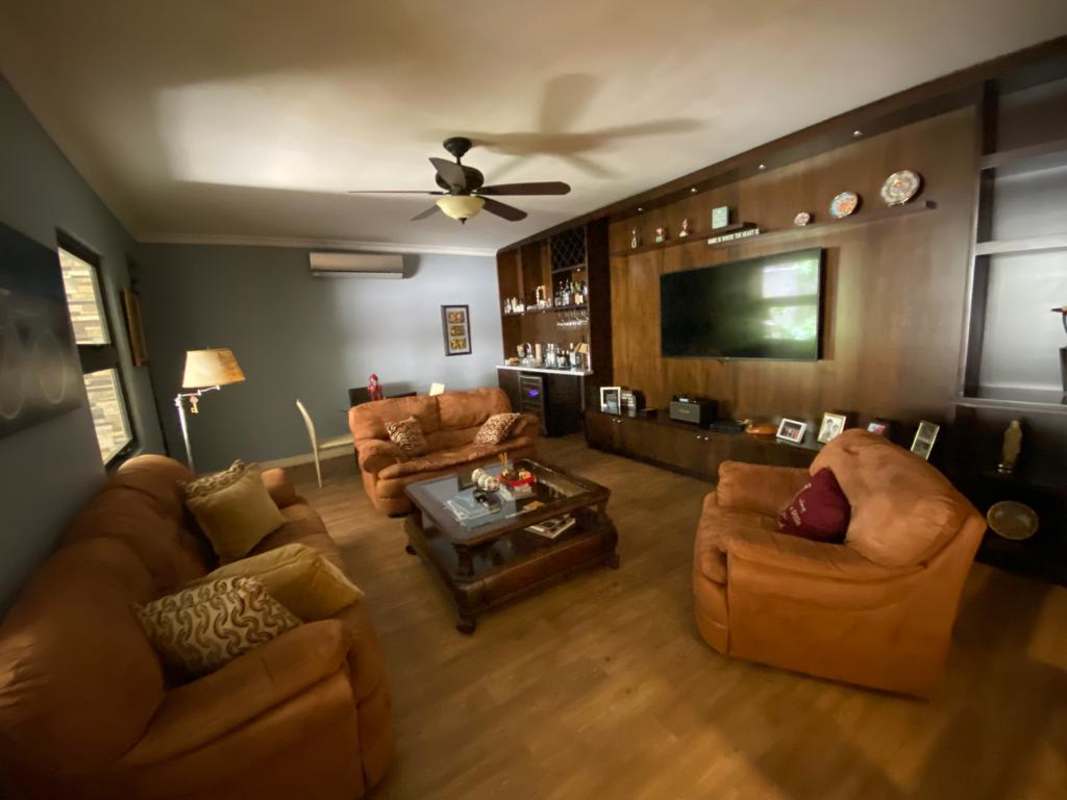 Living room with TV wall unit, fan, sofas PH Palmeras del Este Costa del Este Panama