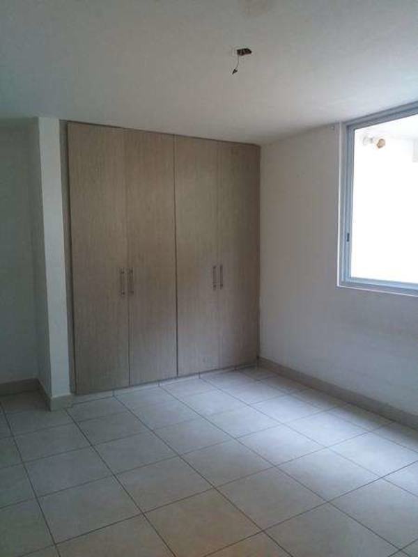 Bedroom with built-in wardrobe and window at PH Belview Tower Edison Park Panama