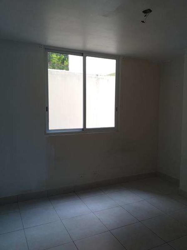 Empty bedroom with large window and tiled floor at Belview Tower Panama