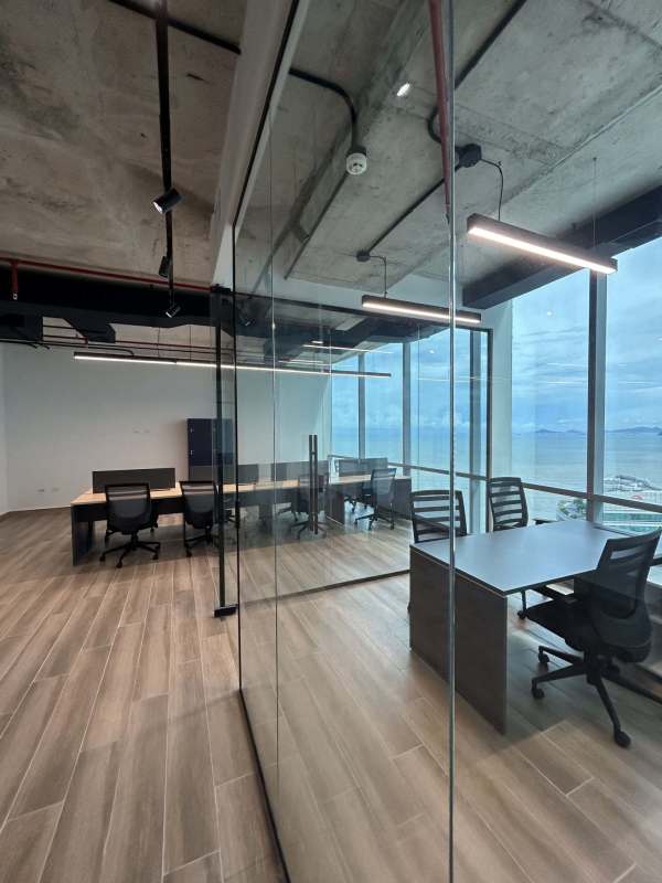 Open office workspace with panoramic windows to city and ocean Financial Park Panama