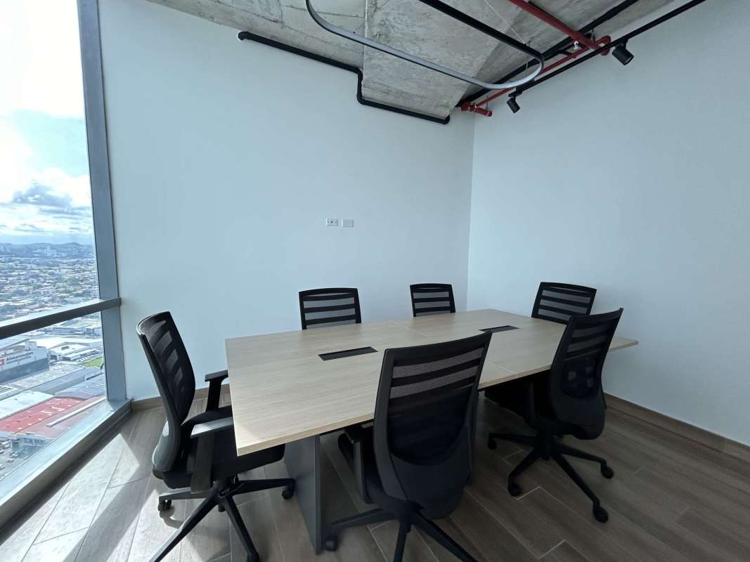 Modern meeting room in office with large city-view window exposed ceiling and industrial style Costa del Este Panama