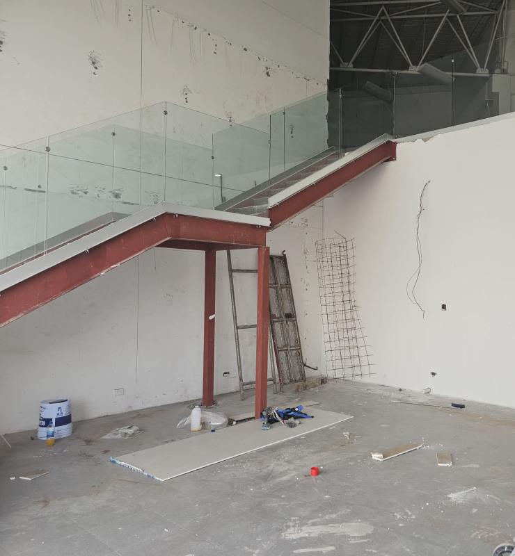 Interior construction commercial unit with metal staircase and glass railing on Calle 50 San Francisco Panama