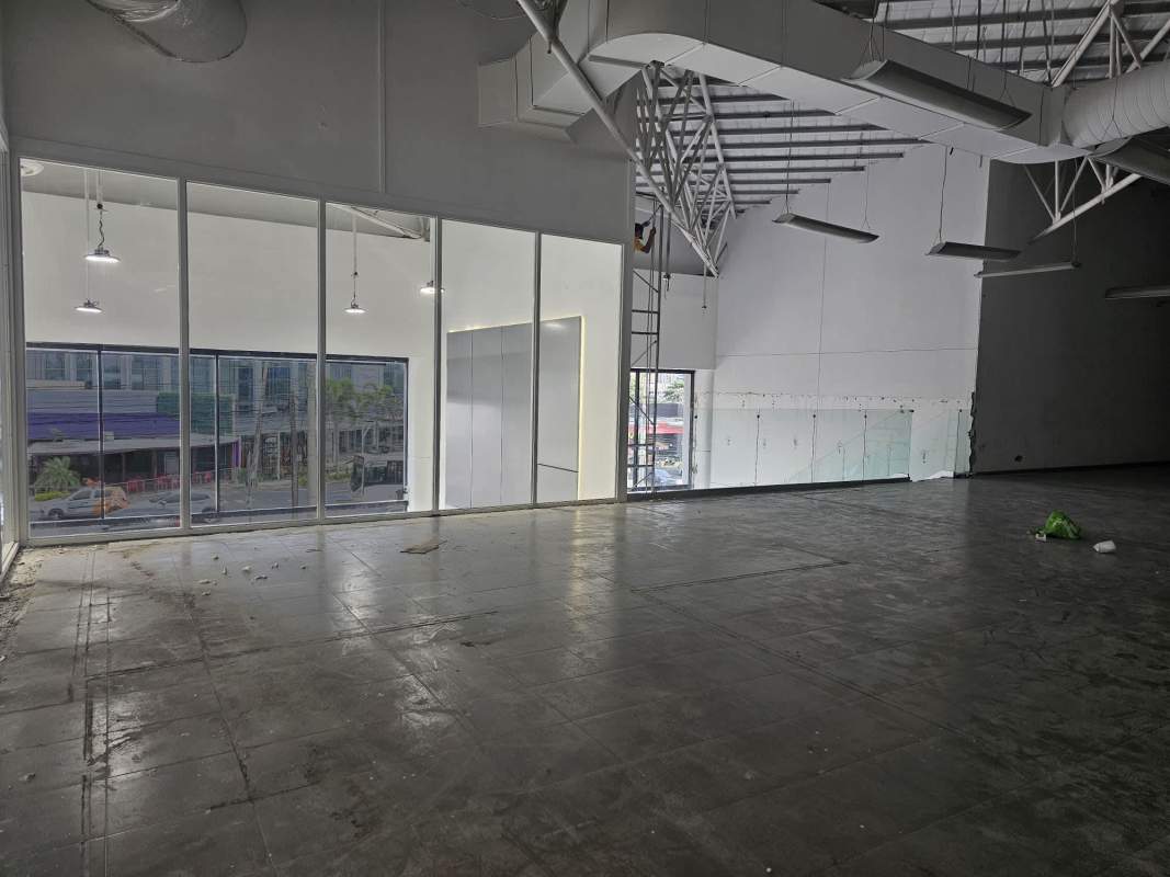 Industrial style commercial interior space featuring large front windows, high ceilings in Panama San Francisco