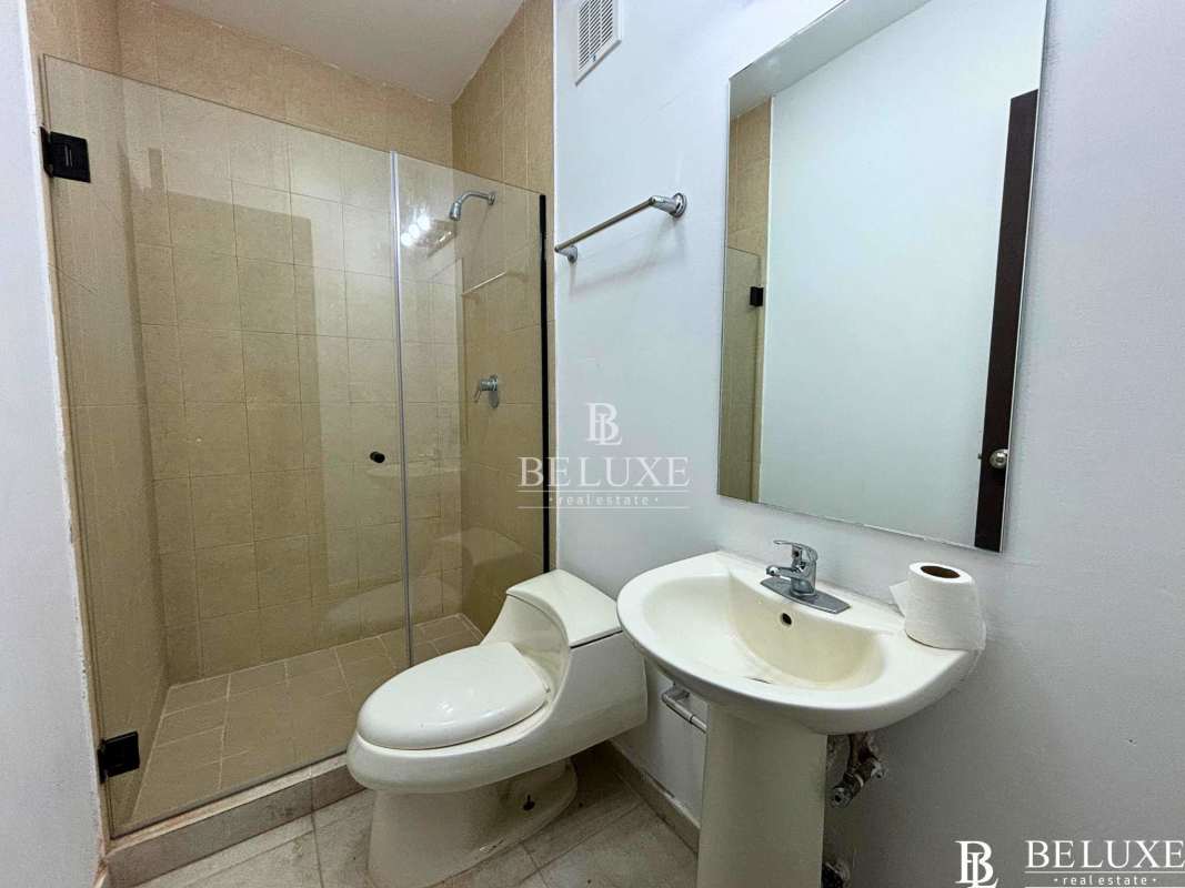 Kitchen with granite countertops, dark cabinets, oven and gas cooktop in PH Seawaves Obarrio Panama