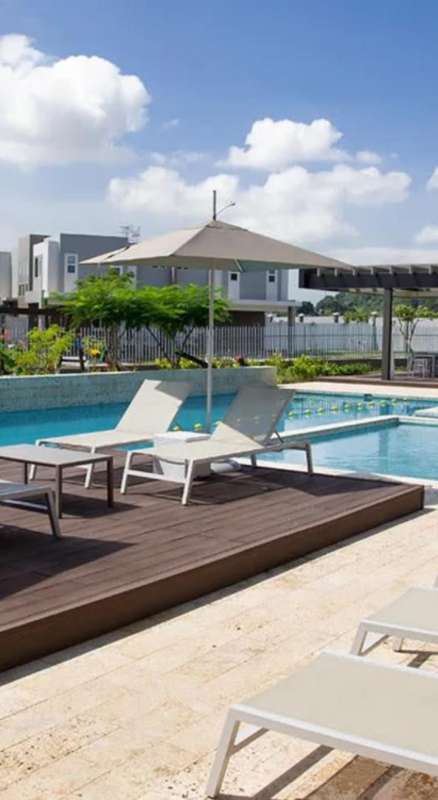 Large residential swimming pool with deck and umbrellas PH Victoria Brisas del Golf