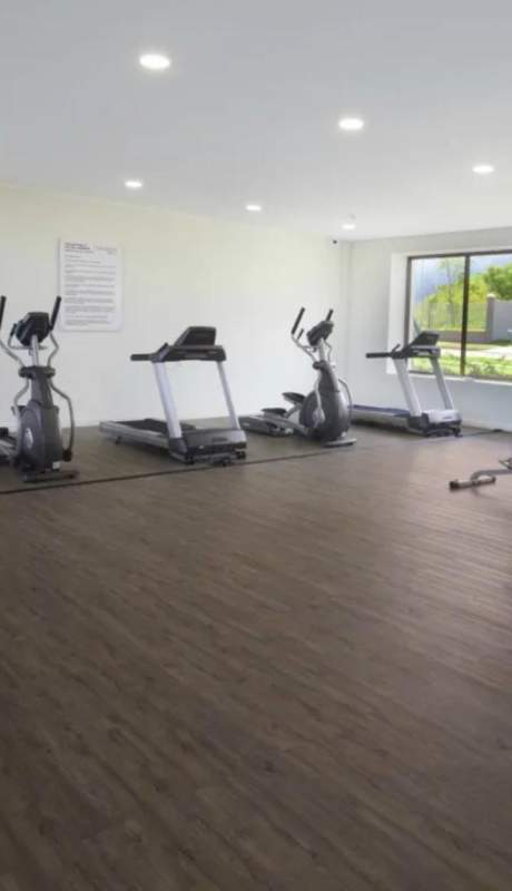 Kitchen with wood finish cabinets and tile flooring PH Victoria house for sale Brisas del Golf