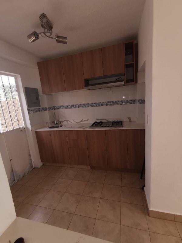 Bright compact kitchen with laminate cabinets and mosaic tile in Panama rental duplex