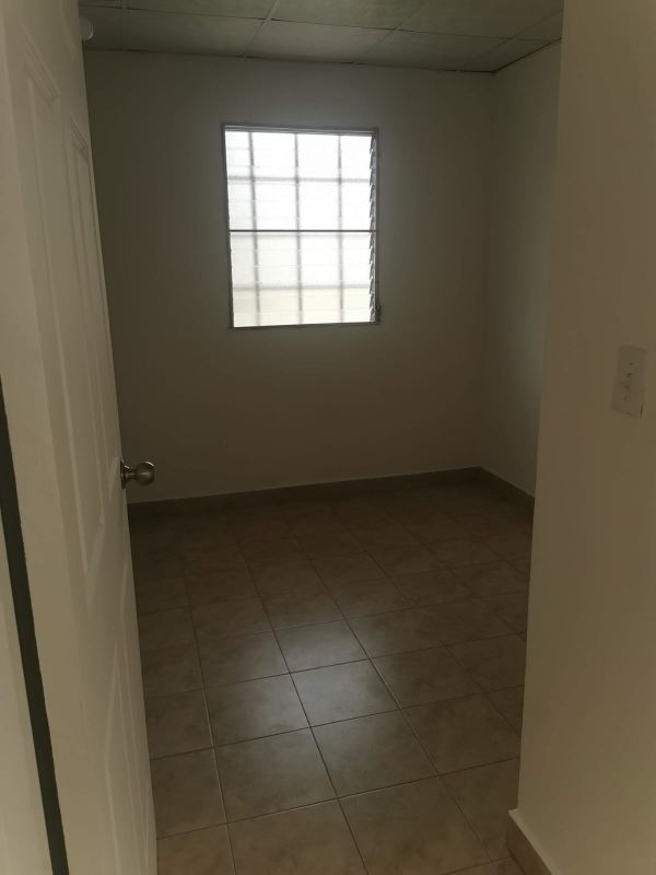 Modern two-story corner duplex exterior with driveway and balcony in Panama City