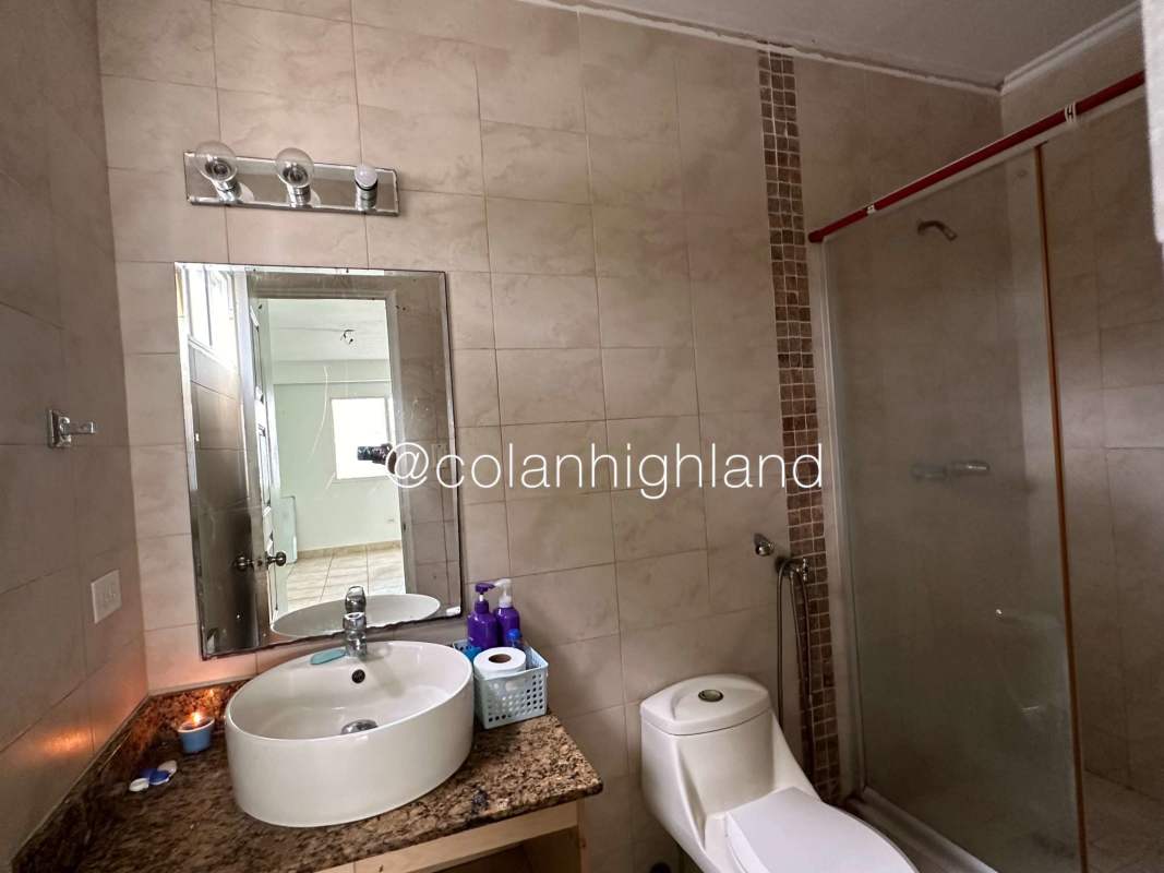 Modern bathroom with glass shower, granite sink and mirror at PH Everest Brisas del Golf Panama
