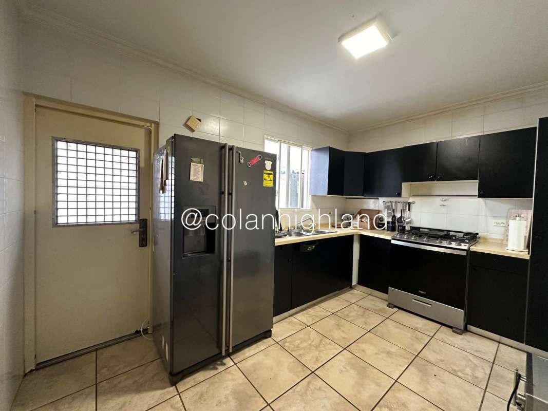 Kitchen with black cabinets, double door refrigerator, gas stove in PH Everest Brisas del Golf Panama