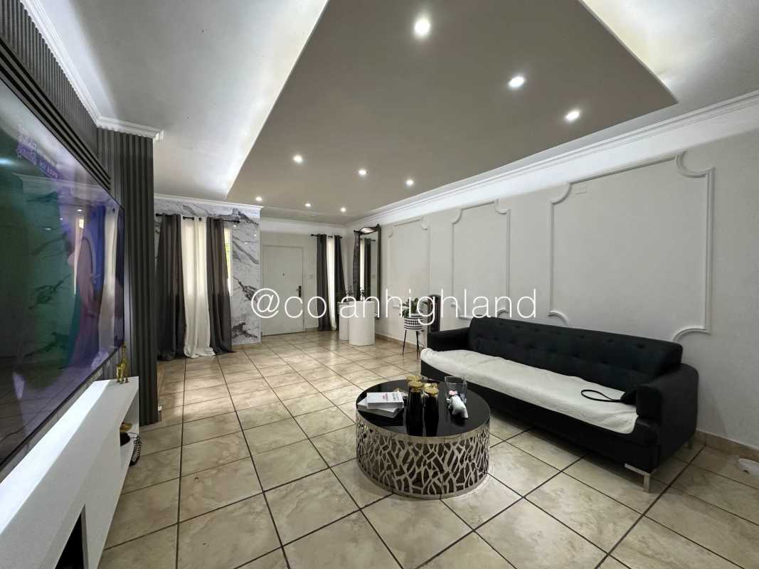Spacious living and dining room with tile floor accent marble wall and recessed lighting at PH Everest Panama