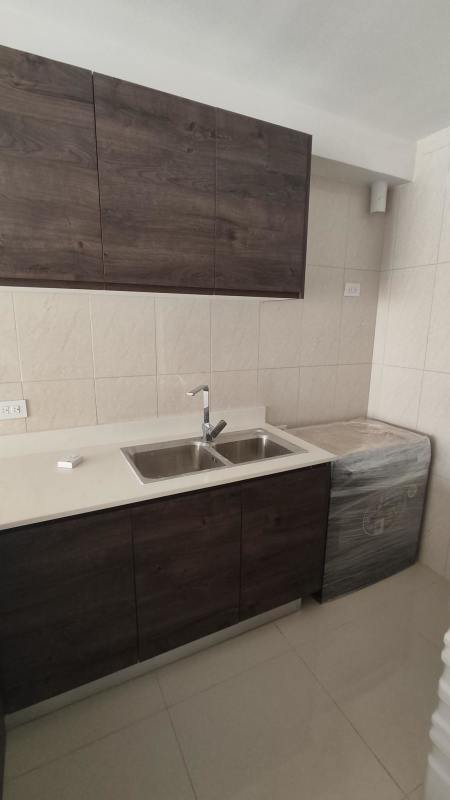 Modern bedroom with large window, tiled floors and neighborhood view in PH Vía España Residences Panama City