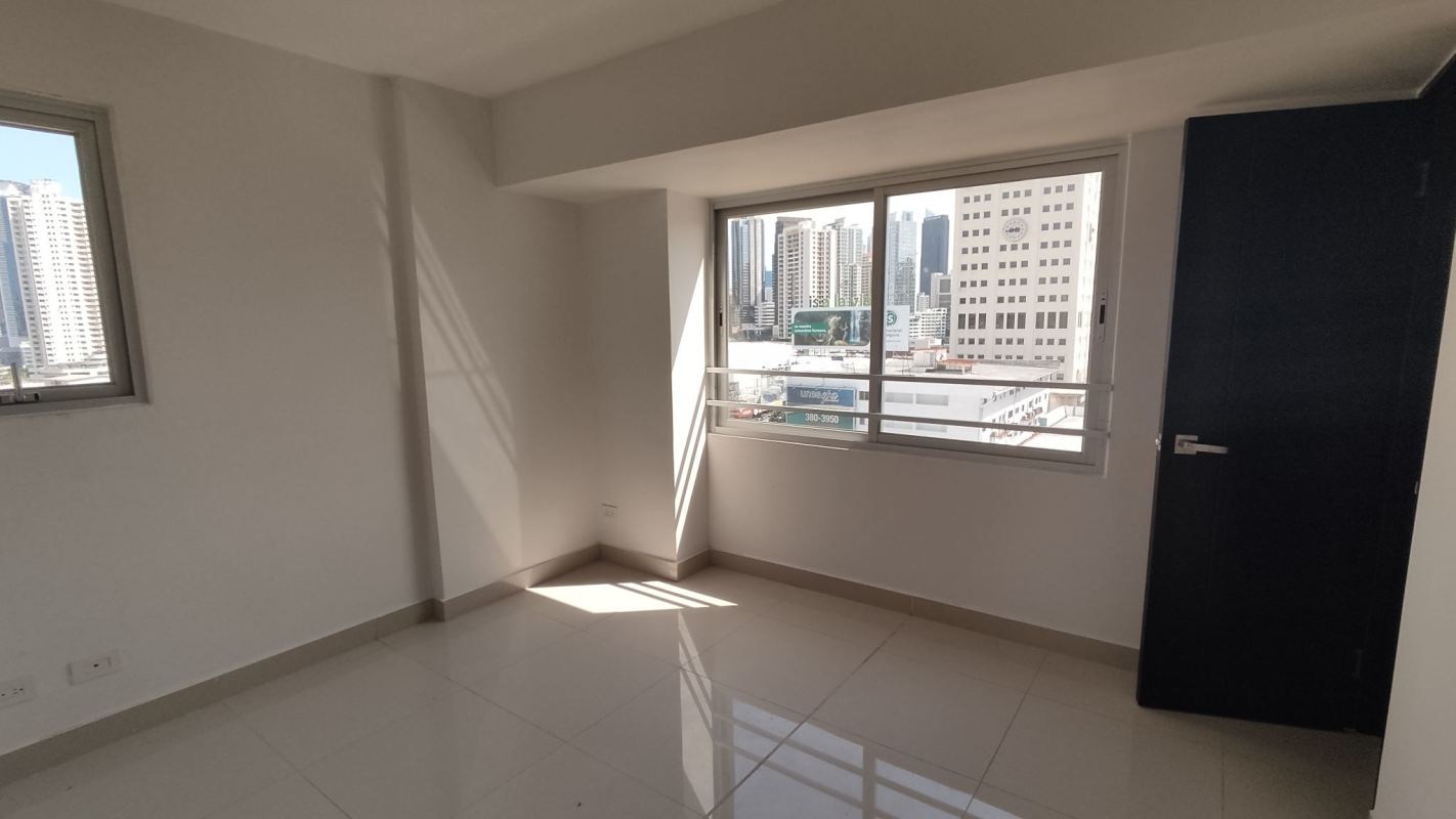 Bright open-plan living dining with sliding doors balcony, tile flooring apartment PH Vía España Residences