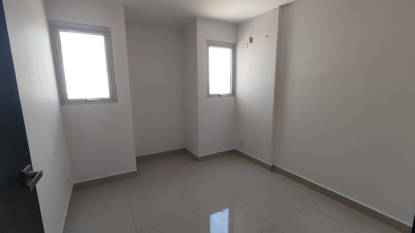 Minimalist bedroom with large window and ceramic tile at PH Vía España Residences Panama