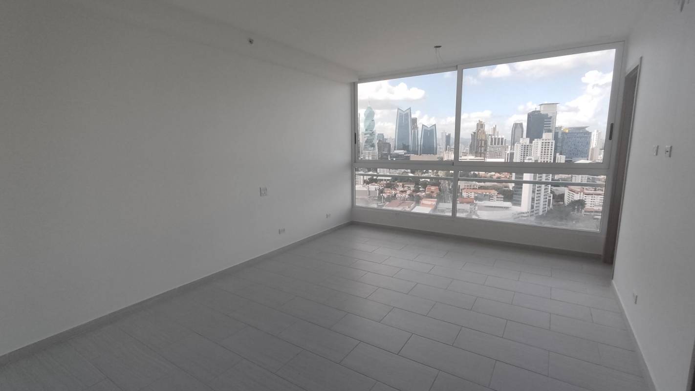 Large empty living space opening to balcony with city views The Towers Panama
