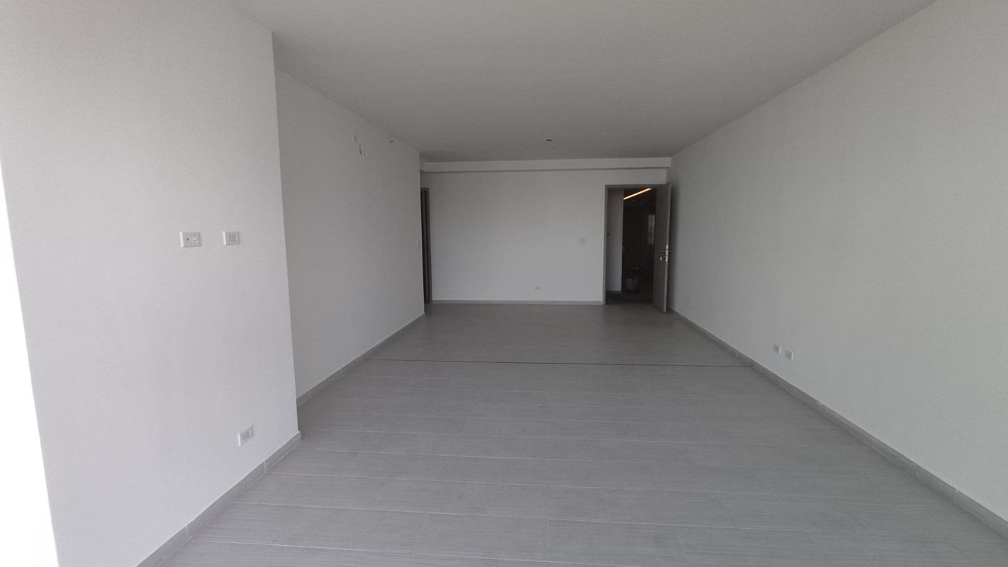 Modern empty living room space with large windows and tiled floors at The Towers San Francisco Panama