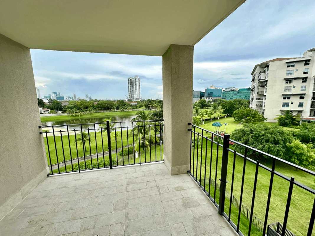 Covered balcony with golf course, lake, city and gardens at The Reserve Santa María Panama