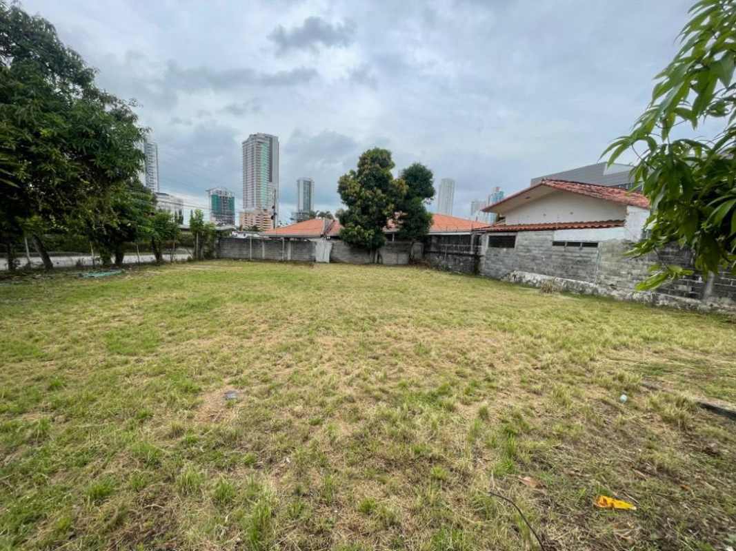 Fenced open lot with grass and shade trees in Altos de Golf neighborhood Panama City
