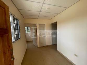 Spacious front green yard with chain-link fence in front of new apartment complex in Santiago Veraguas Panama