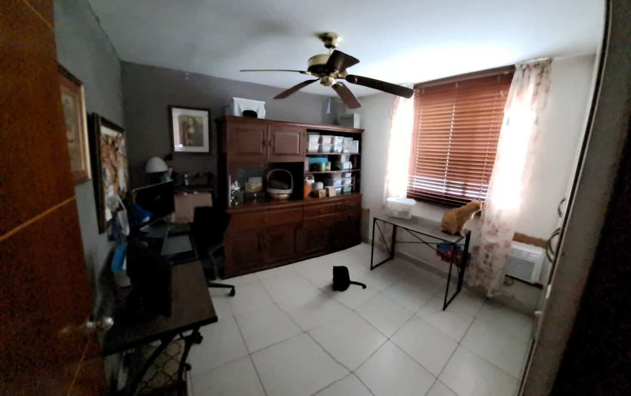 Dining and lounge with wood wall accent, window with curtains in PH Central Park Panama City