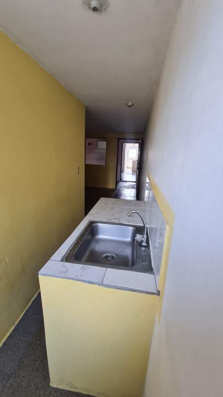 Simple empty room with barred window and mixed tile floors at PH Morya