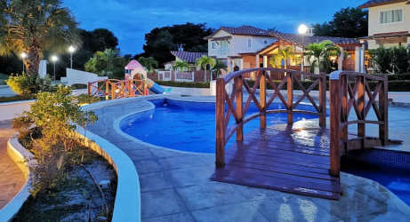 House exterior with terrace, pool, garden and bridge at PH Fontanella del Mar in Panama beach community