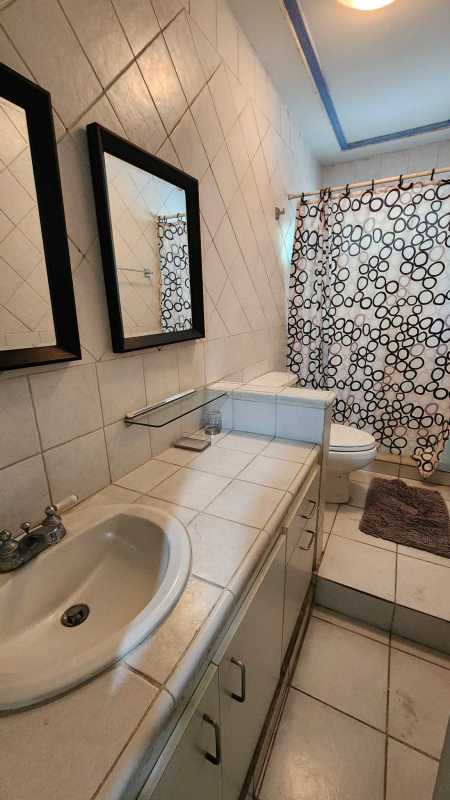 Modernized bathroom featuring black fixtures glass shower white tiles Marbella Panama