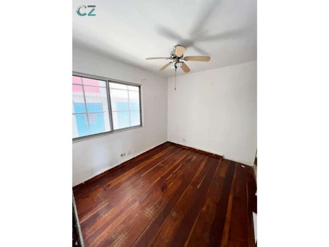 Bedroom with large window, ceiling fan, laminated floor in Coco del Mar apartment Panama City