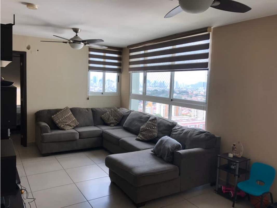 Contemporary living room with sectional sofa, ceiling fans, large window with roller blinds and city view in PH Kings Park Condado del Rey