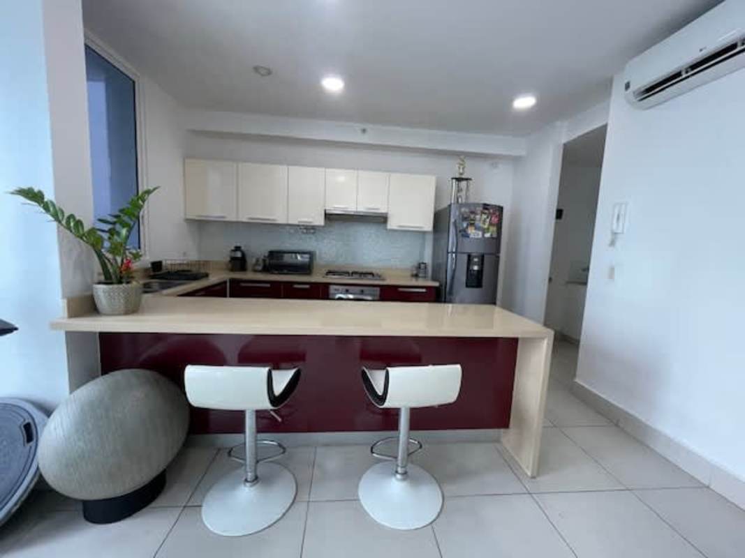 Kitchen with breakfast bar, granite countertops, and appliances PH Castellammare Panama