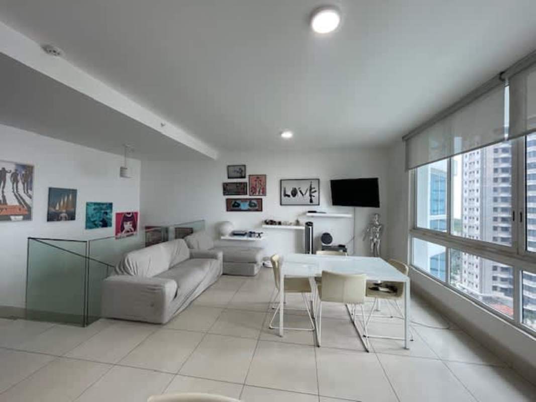 Open concept living dining room with large windows in PH Castellammare duplex Panama