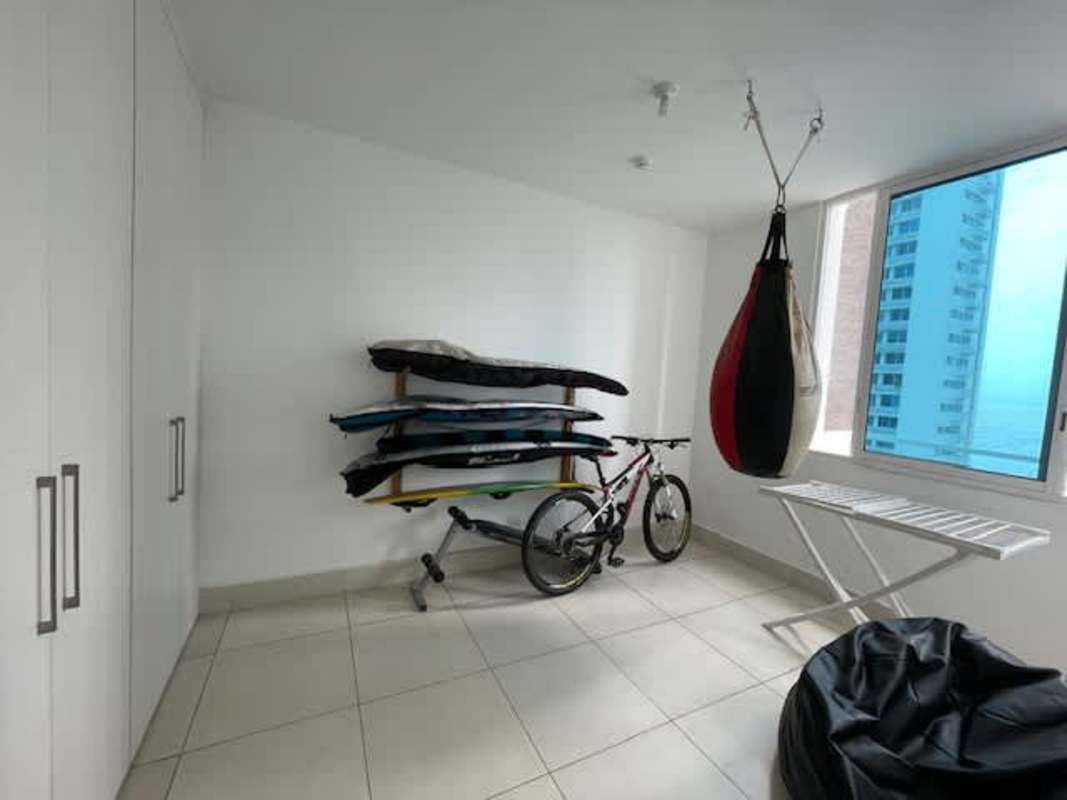 Modern bedroom with large window built-in closet and ensuite bath in Costa del Este apartment