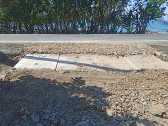 Newly developed roadside with drainage near Caribbean Sea by tropical beach in Colón Panama