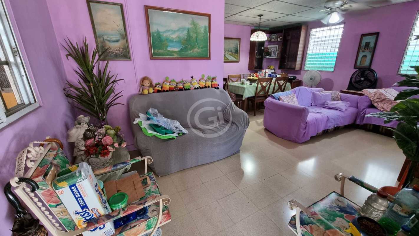 Kitchen area with wood cabinets, tile backsplash, stainless counters in Villa de las Fuentes house Panama