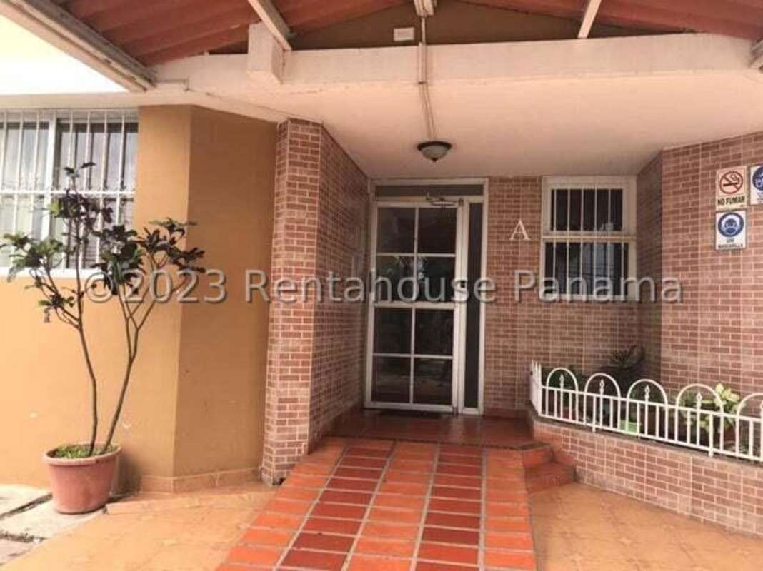 Entrance area with glass doors, brick facade, and covered porch at PH Campo Limberg Don Bosco Panama