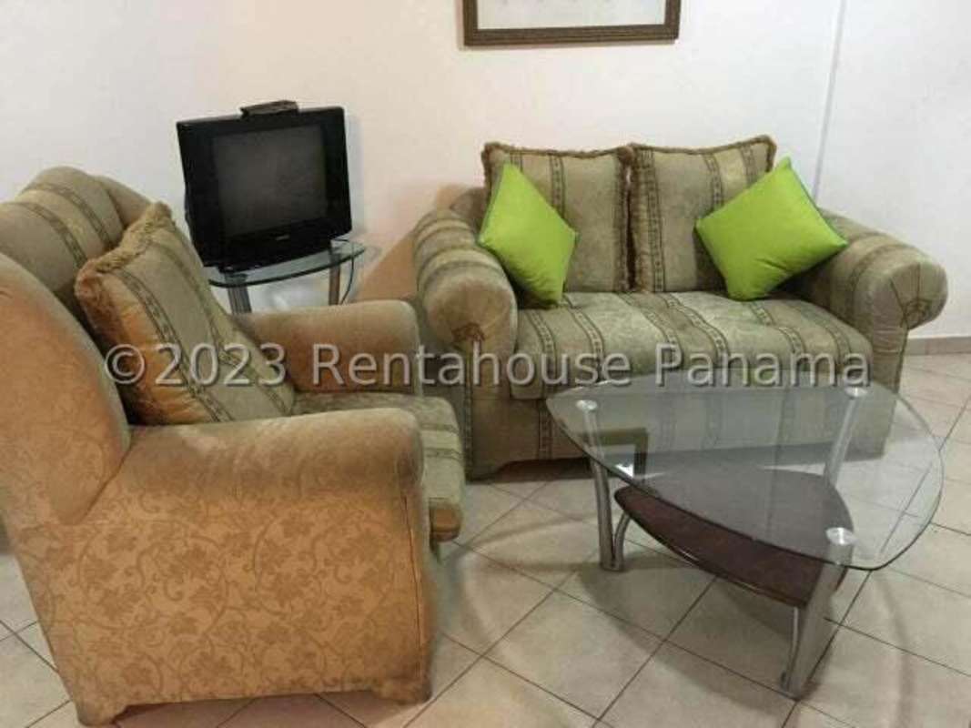 Traditional living room with tiled floor, sofa, TV stand, and wall art in PH Campo Limberg Panama City