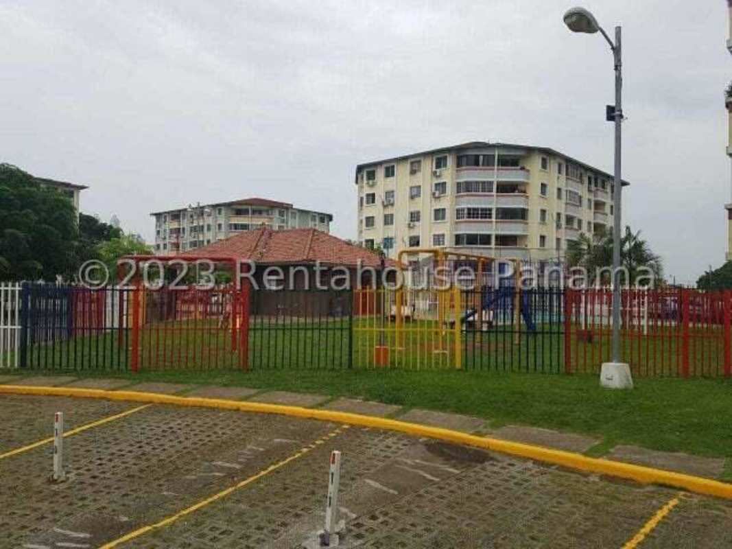 Apartment buildings with gated children's playground and green landscaping at PH Campo Limberg Panama